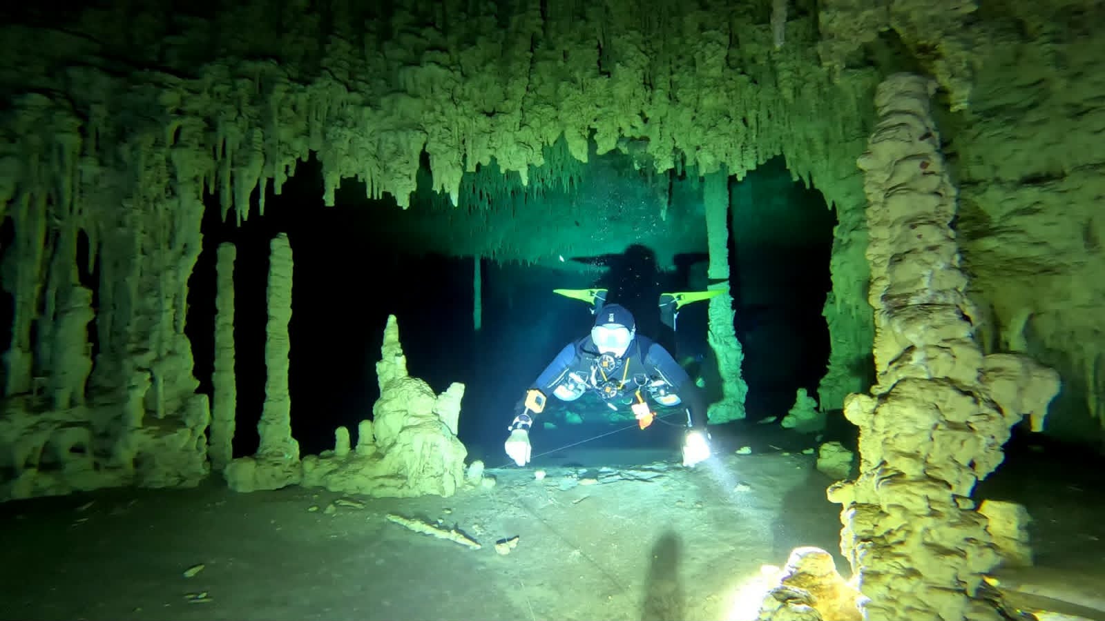 Cave diver among stalactites in Cueva del Agua