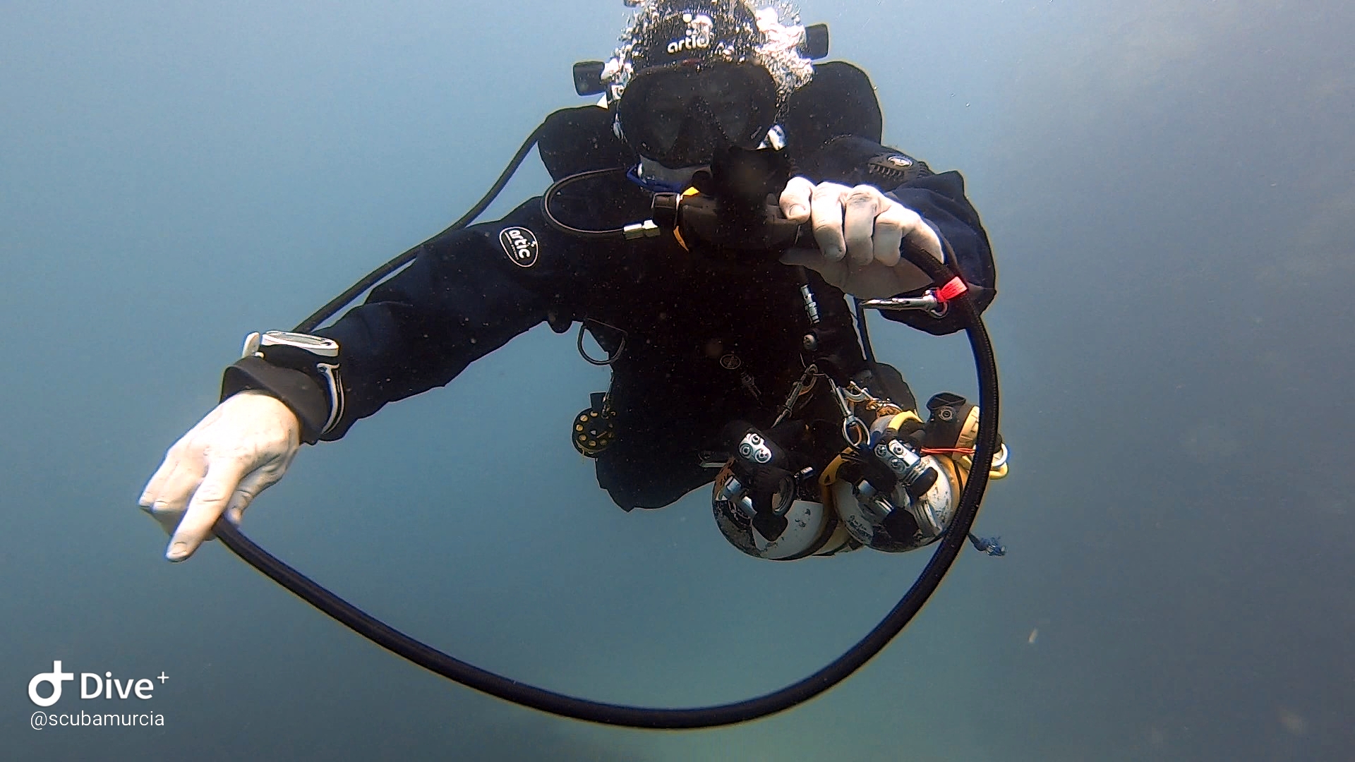 Technical diver underwater on twinset
